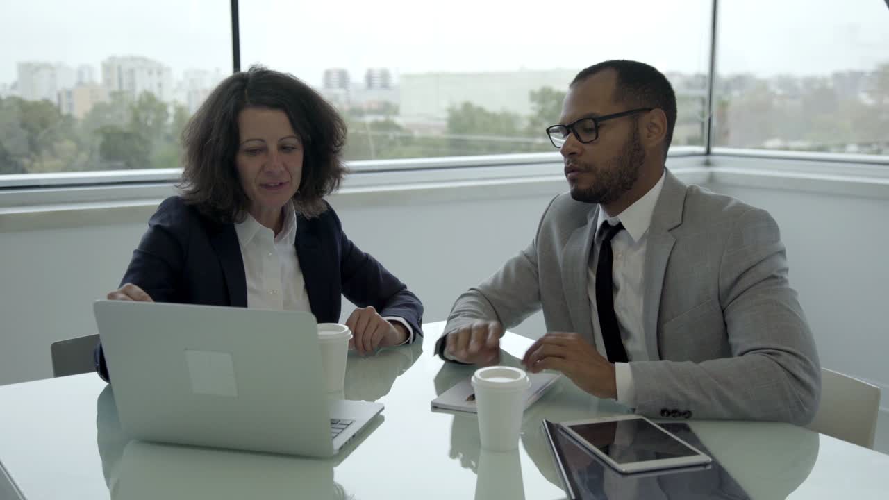 Smiling manager talking with client in office