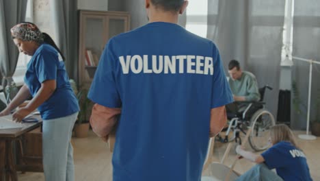 volunteer carrying cardboard box