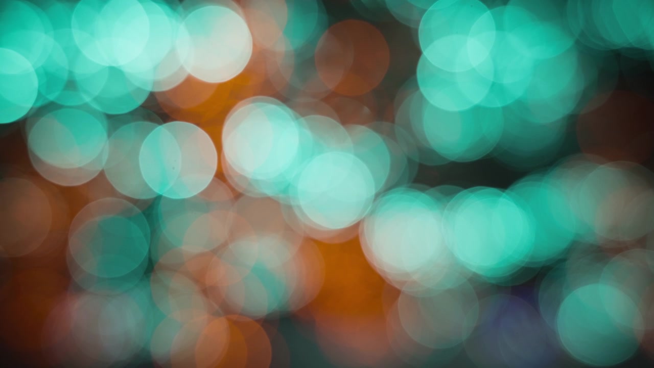 Luci sfocate verde acqua e arancioni