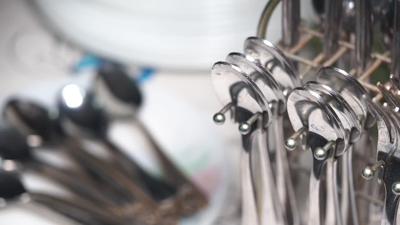 Close-up of Stacked Cutlery on a Rack