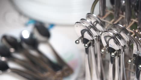close-up of stacked cutlery on a rack