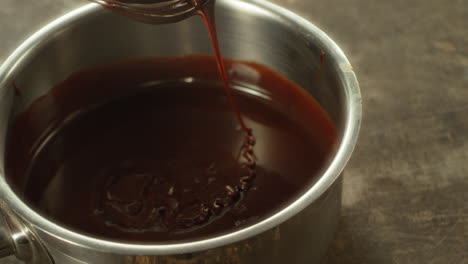 closeup melted chocolate mixing in slow motion. macro of liquid chocolate