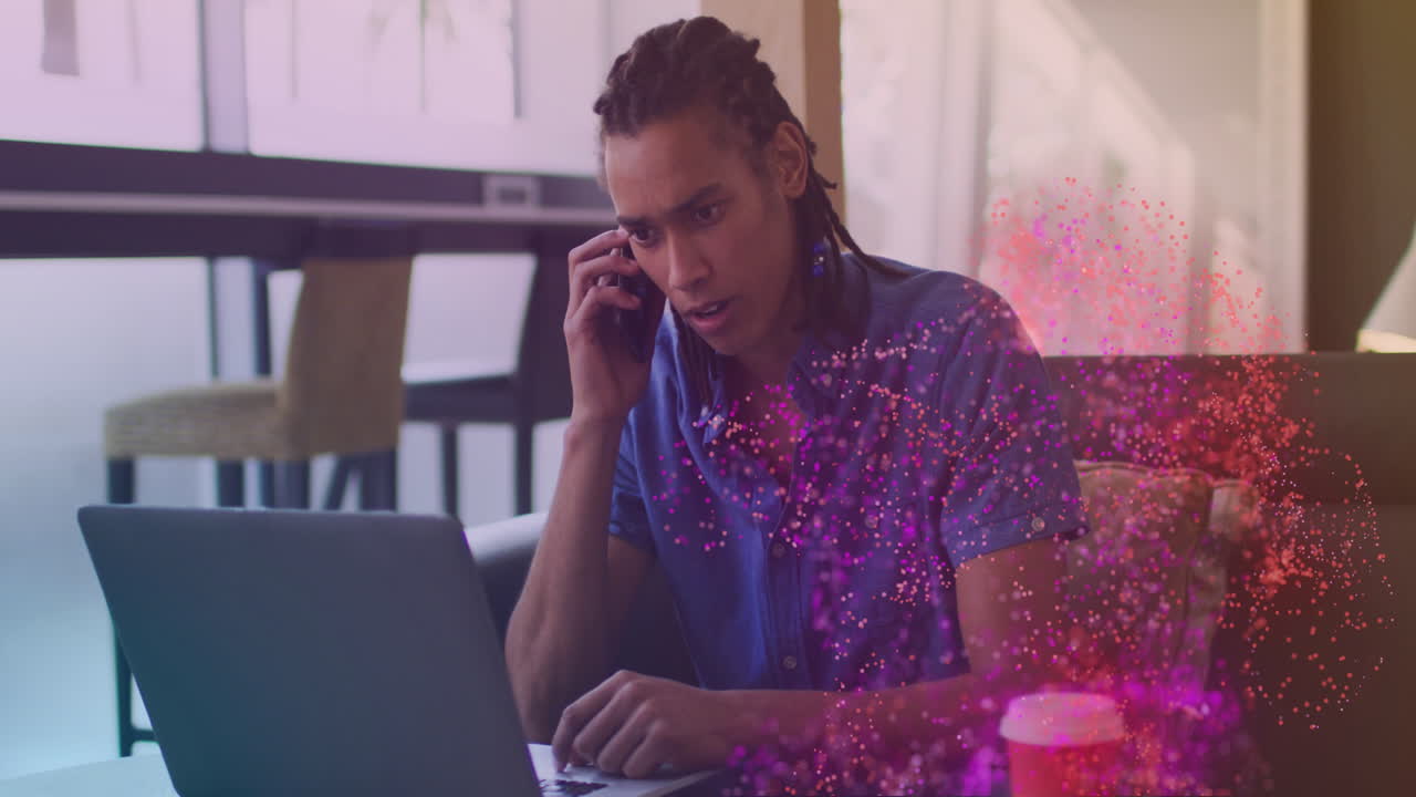 Animation of spots over biracial businessman talking on smartphone