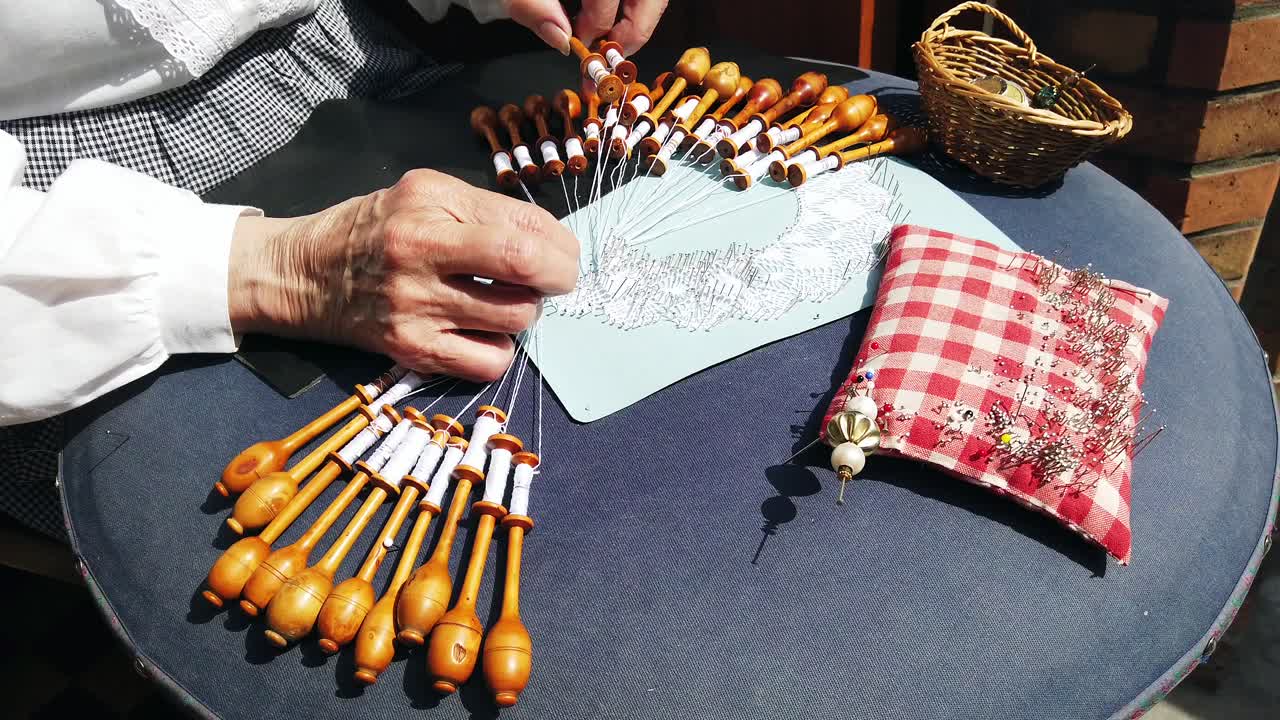 Old woman making lace with the bobbin lace technique in Antwerp, Belgium