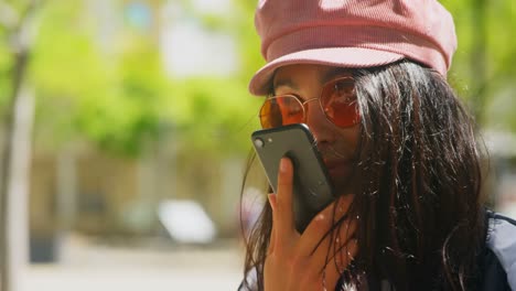 young woman talking on mobile phone in the city 4k