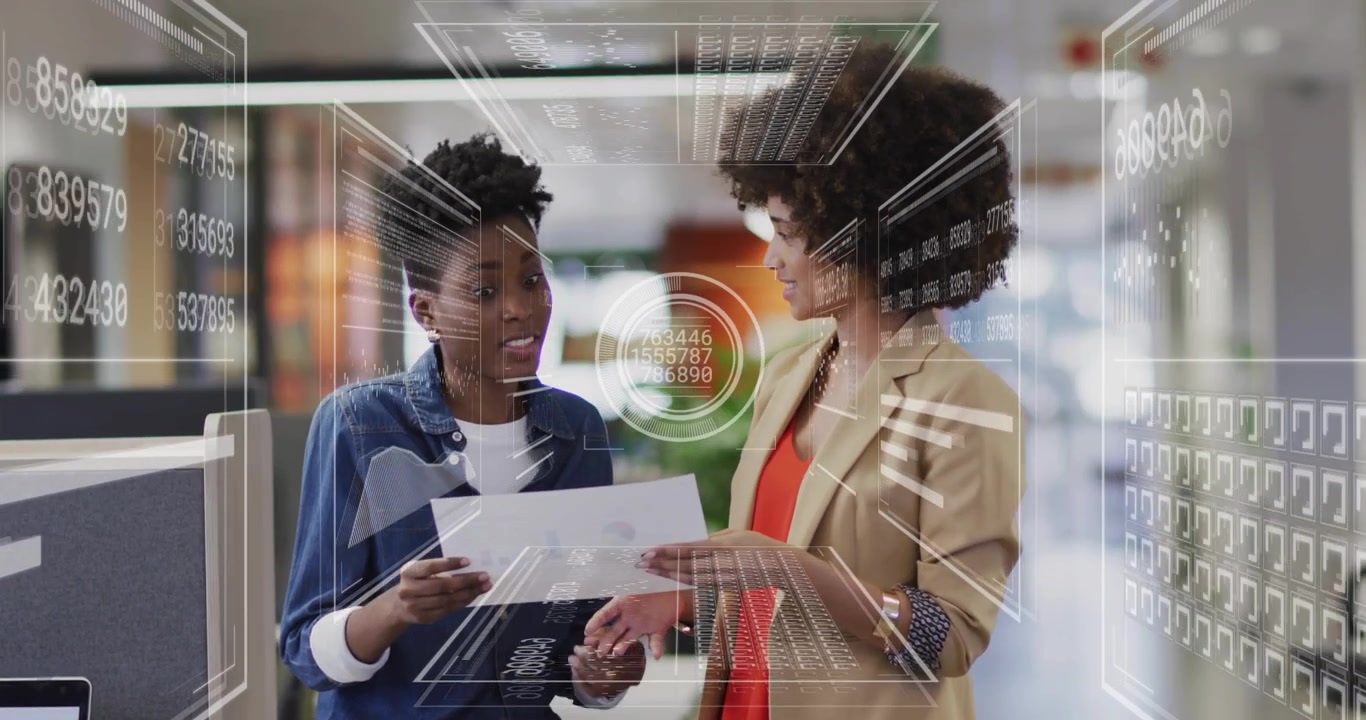 Two Businesswomen Discussing Data and Documents in Modern Office with Digital Overlay