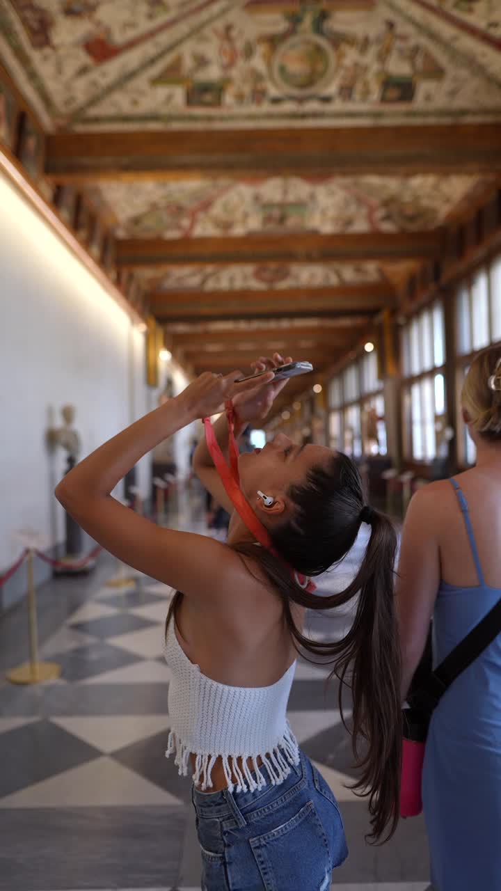 Teenage girl taking picture in a museum