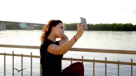 woman taking selfie by the river