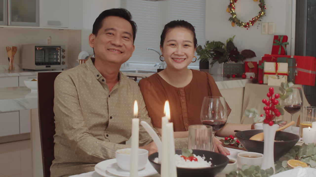Asian Spouses Celebrating Christmas at Table