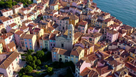 aerial view of a colorful coastal town with a church by the sea