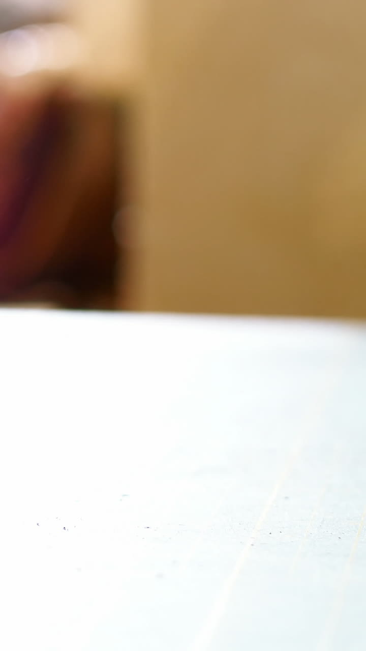 Mid-section of craftswoman rolling up the sheet of leather on work tool
