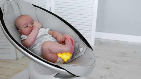 modern high-tech rocking chair helps parents put the child to bed. white interior of children's room