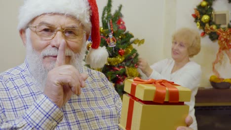 senior man wearing santa hat want to make suprise for his wife