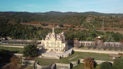 aerial view of a historic castle-like building in a park