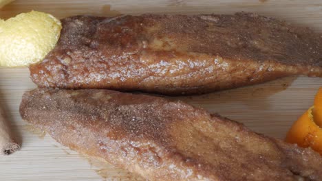 sweet torrijas with a cinnamon stick and lemon zest, a traditional spanish treat