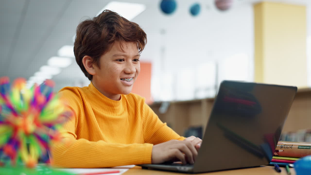 Teenage boy learning on a laptop