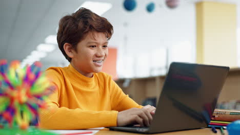 teenage boy learning on a laptop