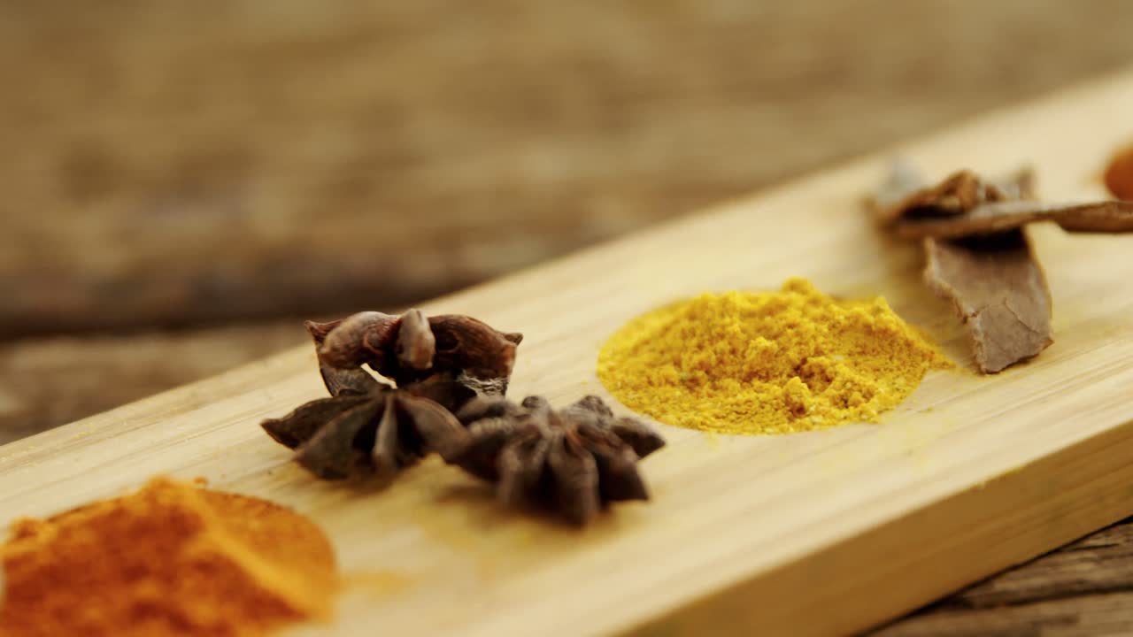 Various spices on wooden tray 4k