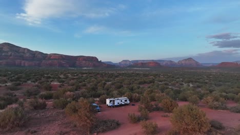 RV-On-Red-Desert-Grassland-In-Sedona,-Arizona---aerial-pullback