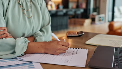 Woman working on financial documents at desk