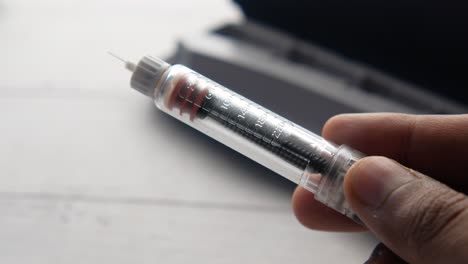 insulin syringe in hand