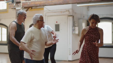 long shot of happy people dancing and having fun in ballroom