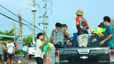 people enjoying a playful water fight outdoors