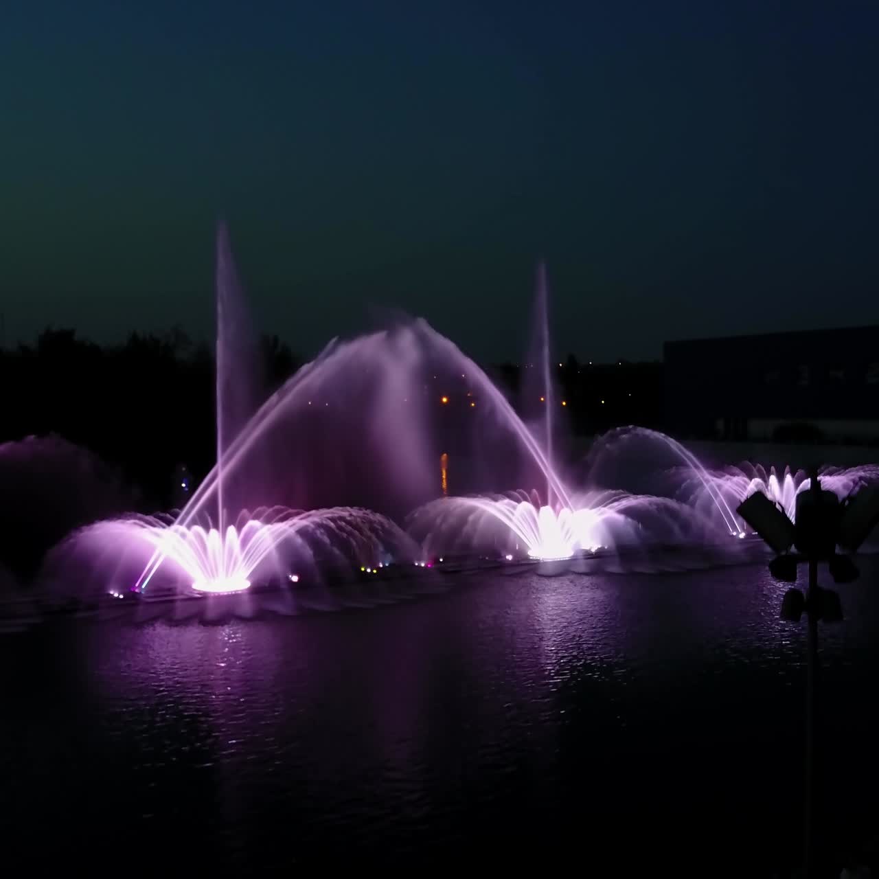 Music Fountain On The River. Aerial shot of the beautiful night performance of colorful fountains