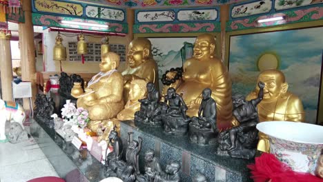 large golden buddhist statues adorn a chinese temple in thailand