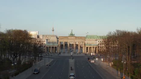 AERIAL:-Flight-towards-Empty-Brandenburger-Tor-in-Berlin,-Germany-due-to-Coronavirus-COVID-19-Pandemic-in-Sunset-Light