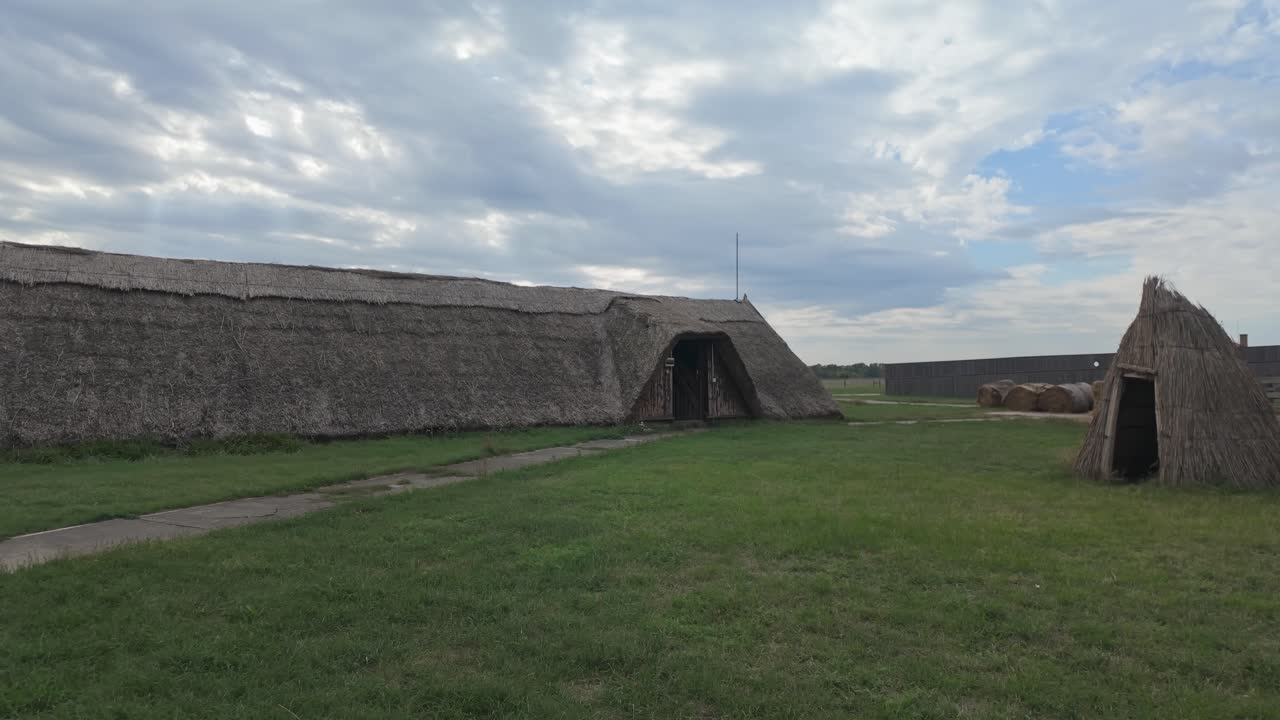 Traditional Hungarian thatched barn in an idyllic farm setting on a cloudy autumn day