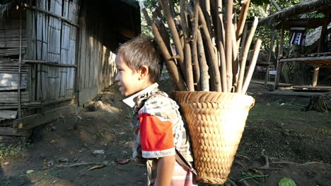 child carrying wood in rural village