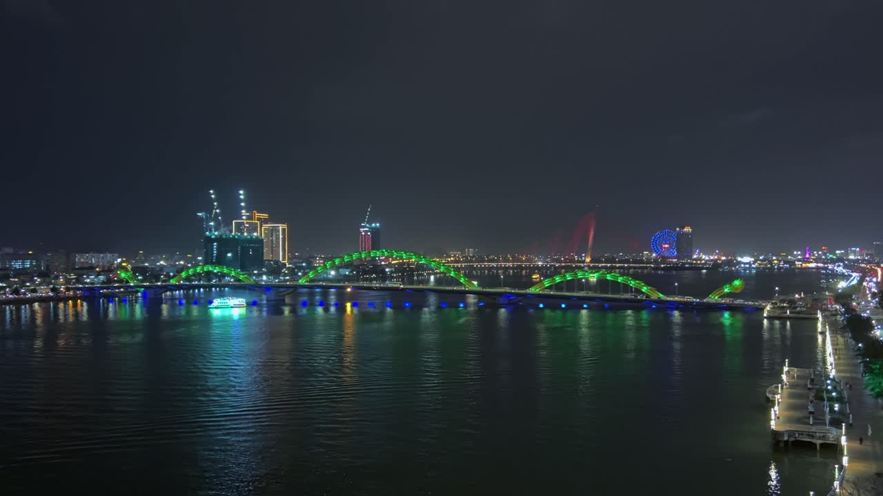 Scenic Night View Of Illuminated Dragon Bridge Across Han River In Da Nang, Vietnam. wide static shot