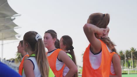 hockey coach talking with female players