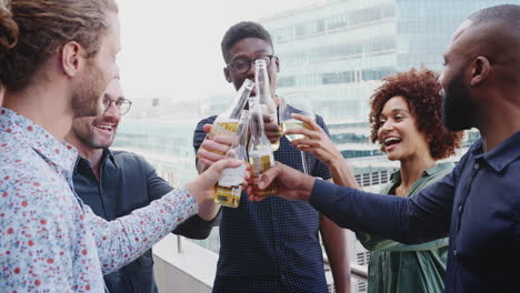 five creative business colleagues making a toast with after work drinks in the city, close up