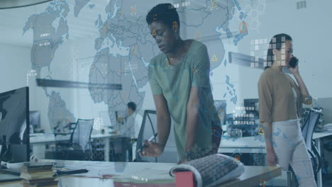 animation of circuit board pattern on map over african american woman analyzing report on desk