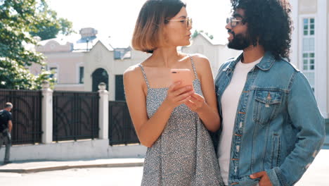 couple using phone outdoors