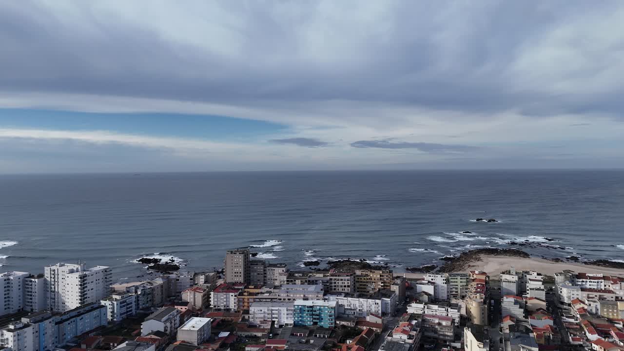 Aerial - rotating drone view of Póvoa de Varzim cityscape and Atlantic coastline, Portugal