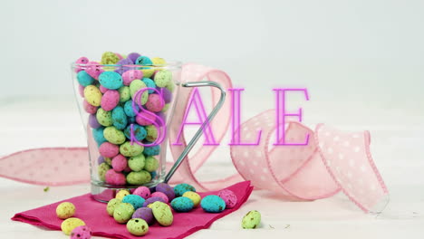 sale text overlay on colorful candy eggs in glass cup, creating animation