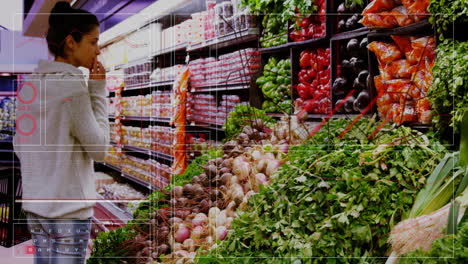 shopping for fresh vegetables, woman viewing digital animation in grocery store