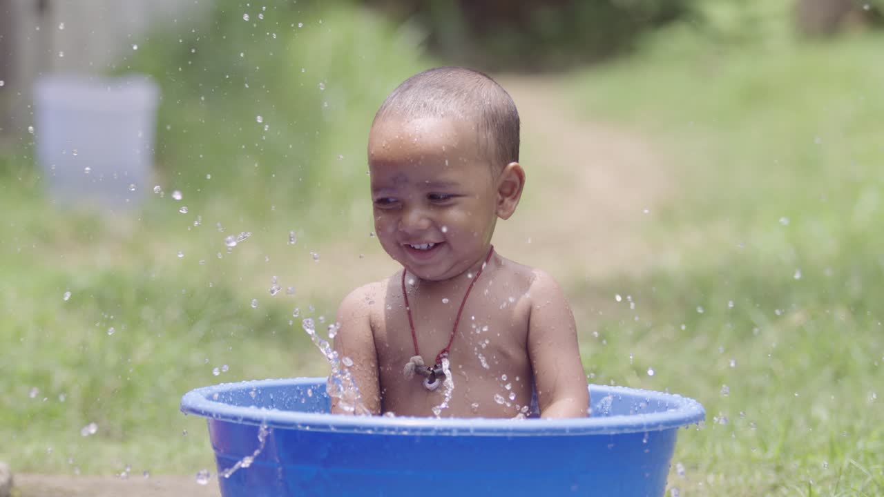 The baby is taking a bath