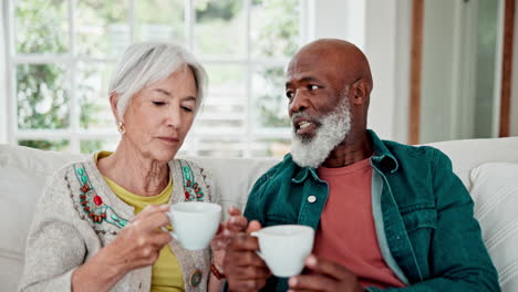 Senior-couple,-coffee-with-communication-on-sofa