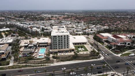 Counterclockwise-aerial-parallax-around-apartment,-intersection,-Huntington-Beach,-California