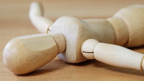 figurine lying on a wooden floor