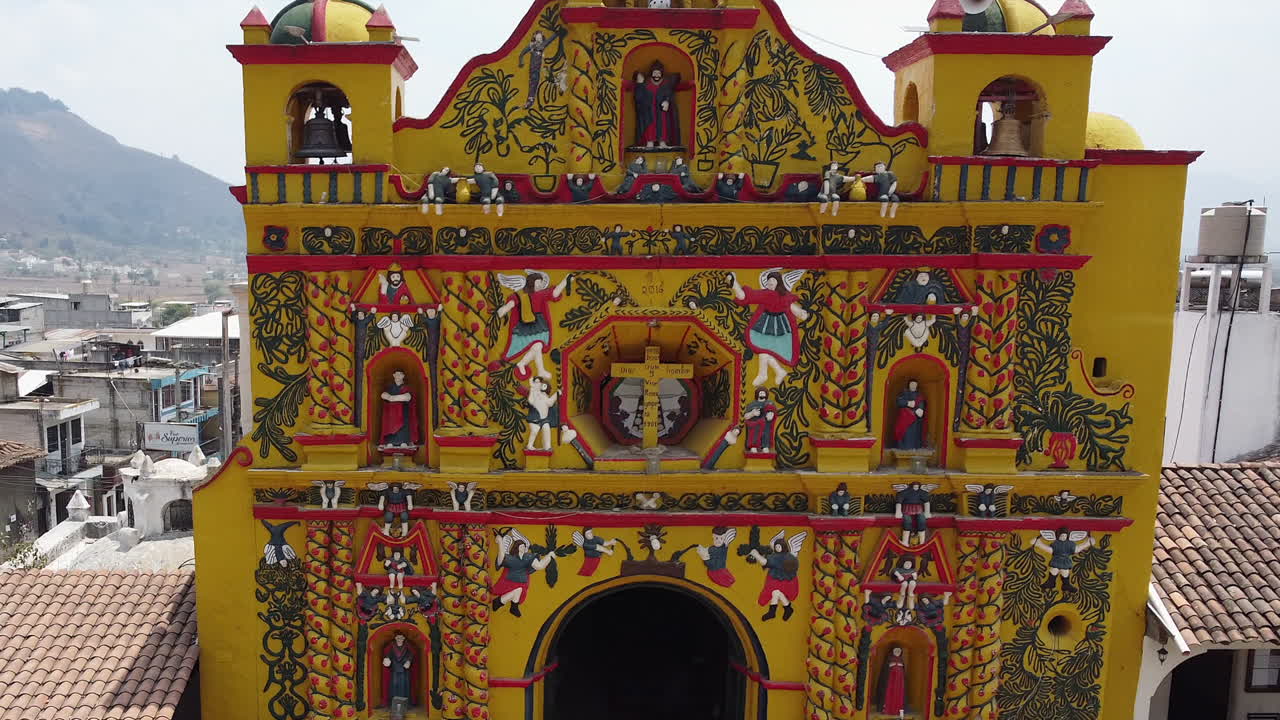 Ornate detail of bright yellow Mayan Church fa&ccedil;ade in San Andres Xecul