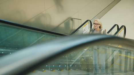 Frau-Auf-Geschäftsreise-Fährt-Rolltreppe