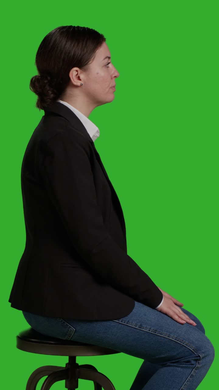 Vertical video: Profile close up of female manager waiting on chair