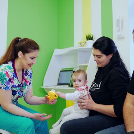 child patient at medical appointment. female doctor sitting on sofa and talking to child patient