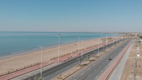 aerial parallax over marine drive beside beach coastline in gwadar
