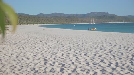 people on small boat arrived at whitehaven beach - white sand beach at whitsunday island in qld, australia